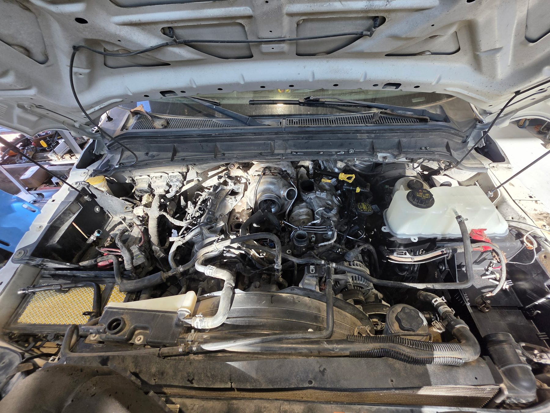 Engine work in progress under the hood of a truck